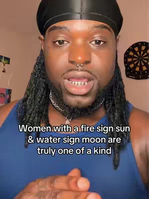 A close-up shot of a Black man with a short beard and long locs. He is wearing a blue tank top and a black durag. Text is overlaid on the bottom of the image.