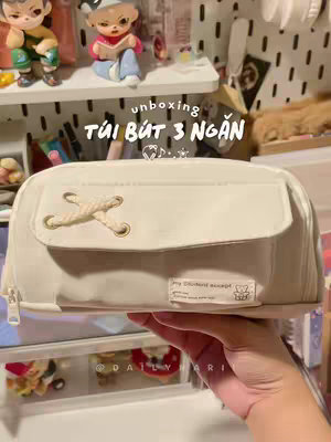 The cover image shows a close-up of a cream-colored pencil case held against a background of stationery items. Bold Vietnamese text overlays the pencil case.