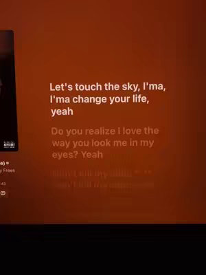 The cover image displays song lyrics on a screen with an orange background. The lyrics are in white, centered, and about a relationship. It shows a shot from inside the screen, with a black border.