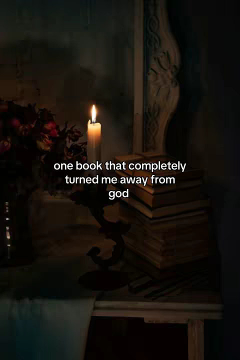 The cover image shows a dimly lit scene with a burning candle in the foreground. Behind the candle is a stack of old books, and there is a vase with flowers to the left. The text overlay reads "one book that completely turned me away from god."