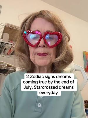 A woman with blonde hair and heart-shaped glasses is centered in the frame. Text is overlaid at the bottom of the image. in the background is shelves and wall.