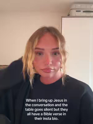 A woman with long wavy blonde hair is posing in front of a neutral background. She is positioned from the chest and up, hand up to her hair. A text overlay at the bottom, black background, informs the viewer about the video content.