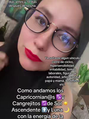 A close-up shot of a woman wearing glasses and bright red lipstick. She is facing the camera, and text overlays are positioned around her face. The background is blurred, suggesting an indoor setting.