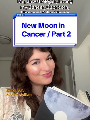 A woman with dark curly hair smiles coyly, holding a journal with a moon image. Overlayed text indicates the video's focus on astrology, specifically a new moon in cancer. The color palette is warm with the woman's skin tone and the text overlays. The background is a neutral, blurred space.
