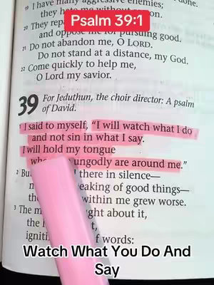 The image displays an open Bible page with a verse highlighted in pink and overlaid text. The open book has text and numbers, where the highlighted verses appear to be from Psalms 39:1. A pink highlighting pen rests over the text. The lower portion of the cover image has text reading, 'Watch What You Do And Say'.