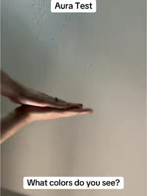 A person's open hands are held up against a plain wall. Above them is text in a rectangle, and below the hands is text.