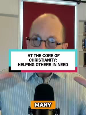 The image features a middle-aged man wearing glasses and a light blue striped shirt, centered in the frame. A microphone with a 'MANY' sticker is positioned below him. Overlaid on the image is a horizontal teal rectangle with white text that states, 'AT THE CORE OF CHRISTIANITY: HELPING OTHERS IN NEED'. The composition is simple, focusing on the man and the message.