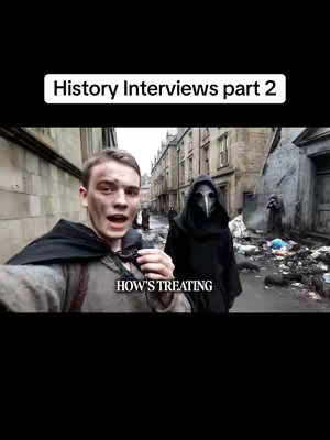 A selfie-style shot with a young man in the foreground, partially obscuring the view. The man is wearing a grey outfit. To his right, a person in a black plague doctor costume with a long beak stands out in the background, amidst a historical setting. The background shows a cobblestone street with buildings and people.
