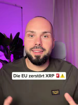 A man with a shaved head and a beard is centered in the frame. He's wearing a muted green shirt, and the background has a blurry purple glow with some plant leaves. A text overlay at the bottom says "Die EU zerstört XRP !" with an alarm icon next to XR and a warning sign.