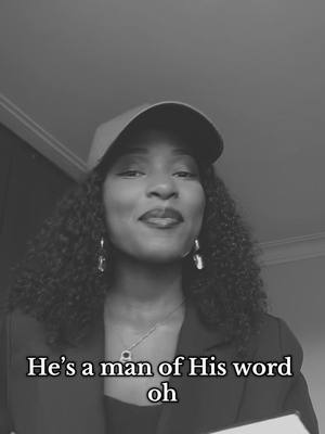 A monochrome image featuring a Black woman wearing a cap and blazer, smiling gently at the camera. Text overlayed at the bottom reads, 'He's a man of His word oh'.