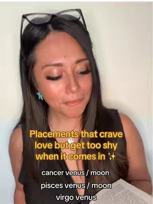 A woman with dark hair and glasses perched on her head looks down and to the side pensively. Text overlays highlight the video's topic. The background is a plain white wall.