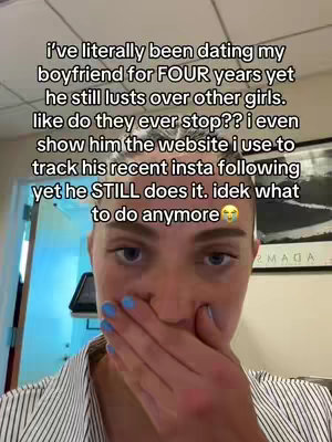 A selfie-style video cover with a woman's face taking up most of the frame. The woman appears to be in her 20s or 30s, she has fair skin, blue nail polish, and is covering her mouth and nose with her hand. The background is blurred and suggests a home or office setting. Text overlayed at the top outlines a relationship issue.