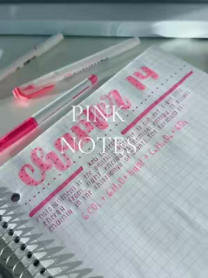 The image shows a notebook with handwritten notes and a few pink pens resting on it. The notes are written in black ink, with key words highlighted in pink. The title "PINK NOTES" is written in large bubbly pink letters. The notebook is open to a page with grid lines and the spiral binding is visible at the left. The color palette is soft, with pink, white, and light-colored inks. The layout is simple and neat, emphasizing the beauty of the handwriting and the color coordination. The overall composition has a sense of simplicity and aesthetic appeal.