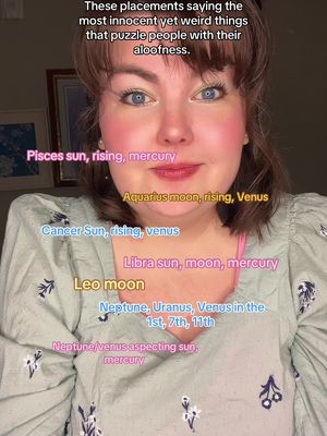 A close-up shot of a woman's face with astrological sign labels overlayed on her face. She has fair skin, dark hair, and is wearing a light-colored blouse with floral patterns. Her eyes are wide and her expression is neutral.