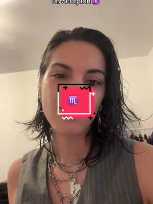 The cover image shows a young woman with dark hair and silver necklaces against a light-colored background. Her face is partially obscured by a red square with a white border and a Scorpio symbol. Additional text overlaying the image reads 'Un Scorpion'.