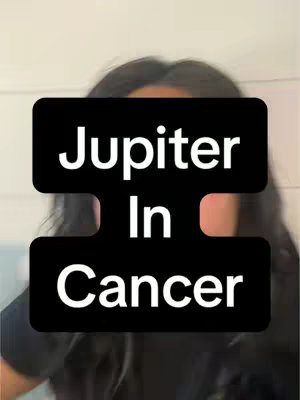 A cover image of a person with long, dark hair from mid-chest up with a large black rectangle overlaying the face. The text overlay displays the words 'Jupiter In Cancer' in white block letters, with the word 'In' taking up the middle portion of the rectangle thus dividing the phrase.