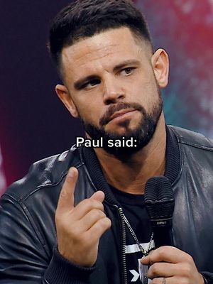 A medium shot of a man with short dark hair, a beard, wearing a dark leather jacket, and holding a microphone. Text overlayed on the image reads "Paul said:"
