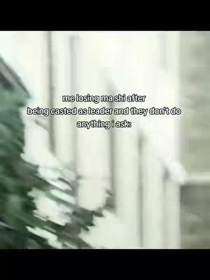 The image features a blurred outdoor scene with text overlaid. In the foreground, the blurred image of trees and possibly other foliage edges the scene. The central focus is the text overlay, which is in a white font and is centrally placed, the text is a meme's caption.