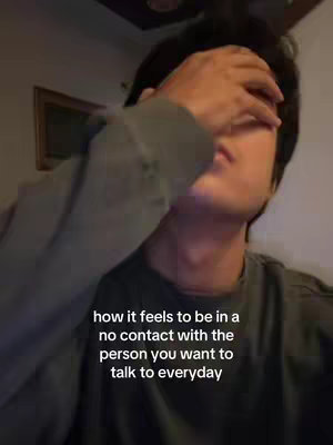 A person is shown with their hand covering their face, suggesting a feeling of sadness or isolation. The background is dark and blurry, further emphasizing the emotional focus. Text is overlaid, describing the feeling of being in no contact with someone you want to talk to every day.