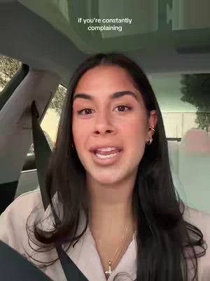 The video shows a woman in a car. She is looking at the camera and talking while the hook is displayed on the upper part of the screen.
