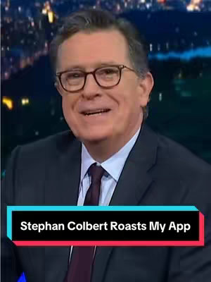 The cover image shows Stephen Colbert, a middle-aged man with glasses, smiling and looking towards the camera. He is dressed in a dark suit and tie, appearing to be on a television set, with a blurred background. At the bottom of the image, a text overlay reads 'Stephan Colbert Roasts My App' in a white font on a black and a teal background.