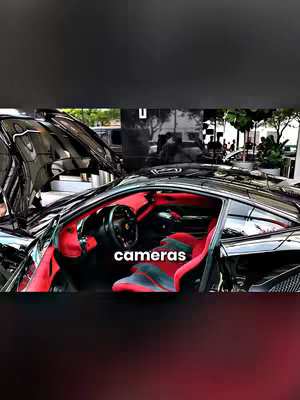 A black supercar is parked with its hood open, revealing a red interior. The words 'cameras' are overlaid on the image.