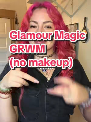 A woman with pink hair is shown from the chest up, smiling and pointing towards the camera. Text overlays are present in the image.