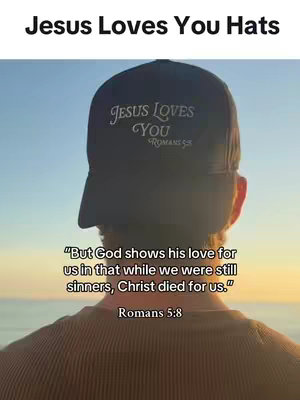 The image shows a person from the back wearing a black baseball cap. The cap displays the text "Jesus Loves You" in white. Below the cap, a biblical verse is superimposed over the person’s back and the background is a gradient of light blue and yellow.
