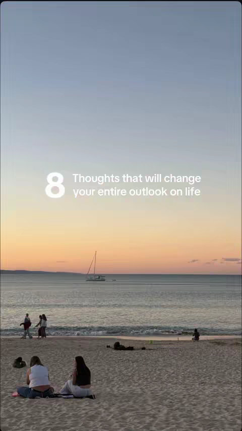 The image shows a beach scene with a sunset.  A sky of blue and orange with ocean and white sand. There are people walking, sitting, and a boat on the water. The text overlay reads: "8 Thoughts that will change your entire outlook on life". 