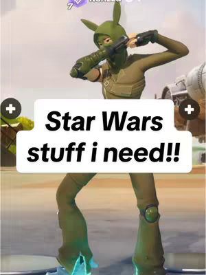 A green character from a video game is posing in the center of the image, holding a futuristic-looking weapon. The character is wearing a green costume, including a mask that covers the face, with an elongated ear design. Text overlaid on the image reads 'Star Wars stuff i need!!'. The background is blurred, suggesting a gaming environment.
