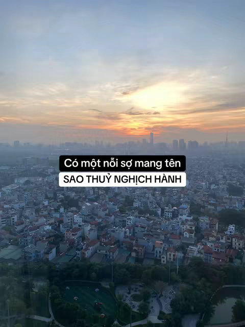 An aerial view of a city at sunset, with a text overlay in the center.