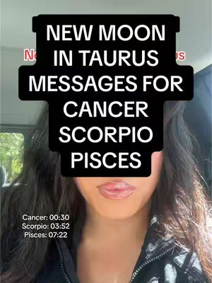 A selfie-style image featuring a person with long dark hair, pink lips, and a black jacket. The face is partially obscured by a black overlay with white text that reads 'NEW MOON IN TAURUS MESSAGES FOR CANCER SCORPIO PISCES'. The background is blurred but seems to be an indoor setting, possibly a car.
