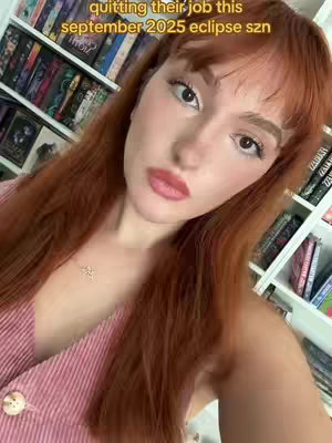 A woman with auburn hair, wearing a pink top and necklace, looks toward the camera. Text overlayed on the image.