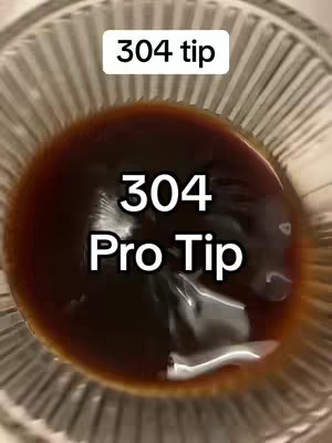 The image shows a close-up of a partially transparent glass bowl containing a dark brown liquid, possibly a beverage or some form of solution, positioned against a blurred background. The text overlay on the top saying "304 tip" and the lower one saying "304 Pro Tip".