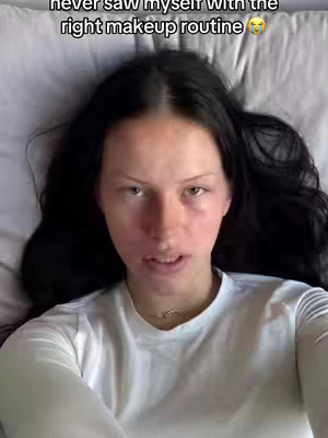 The cover image shows a selfie of a young woman lying on a bed, looking up at the camera. She has long dark hair, and her face is close up, with visible skin texture. She appears to be in a casual setting, with a white shirt, and the background includes a pillow or sheets. The lighting seems natural, possibly from a window.
