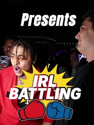 The cover image shows two men in the foreground in what appears to be a live street battle. Text overlays say "Presents", "IRL", and "BATTLING". The background is dark with a crowd, and the text is white with a yellow burst and boxing glove icons.
