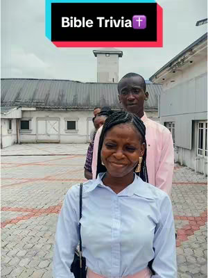 The cover image showcases a group of four people standing outdoors in front of a building. A woman in the foreground is the main focus. She is wearing a light blue button-up shirt with a white collar and has a black purse strap over her shoulder and gold earrings. The woman is showing a subtle smile, as the camera is centered on her. Behind her are three other individuals, each partially visible. The background features a light-colored building and a cloudy sky.
