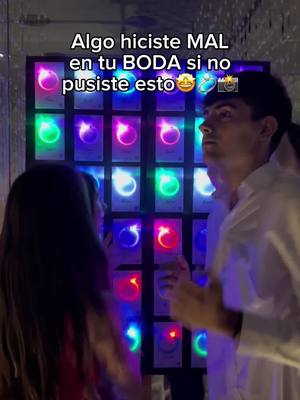 The cover image shows a man and a woman in front of a wall of lit, colorful bracelets. Overlayed text is present. The lighting suggests a nighttime or low-light setting, possibly at a wedding or event.