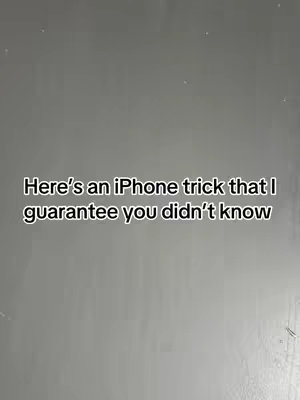 The cover image is a medium gray background with the text overlayed. The overlay says, "Here's an iPhone trick that I guarantee you didn't know." The text is in a clean, sans-serif font and centered on the image.