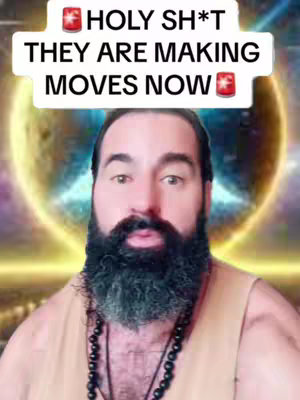 A bearded man with a light brown vest is centered in the frame. Above his head, a white rectangular banner displays bold, black text against a red-accented background. Behind him glows a golden-yellow orb with intricate blue light patterns.