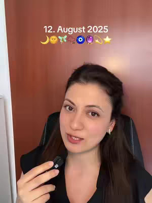 A woman with brown hair and earrings is centered in shot, talking in front of a wooden door. Above her head is overlayed text and emoji.