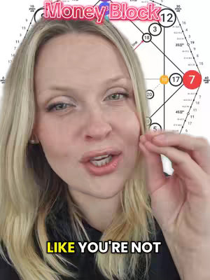 A woman with blonde hair is centered in the frame, speaking directly to the camera. She is gesturing with her right hand near her face. Behind her is a chart with various numbers and lines, with an overlay of text that reads 'Money Block'. The bottom of the image features another text overlay.