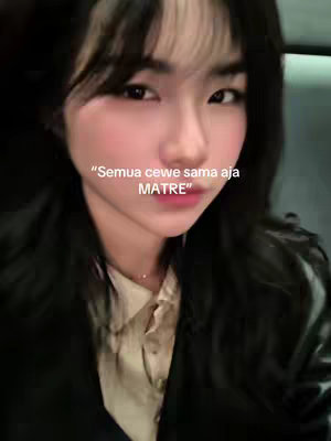 A selfie-style shot of a woman facing the camera. She has long, dark hair and a neutral expression. Overlayed on the image is white text, with a light background.
