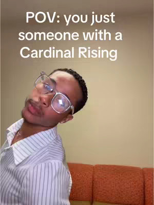 A man with glasses is tilting his head to the side, looking at the camera with a slightly pursed lips. Above him is the text 'POV: you just someone with a Cardinal Rising.' The background is a solid tan color transitioning into a textured orange surface.
