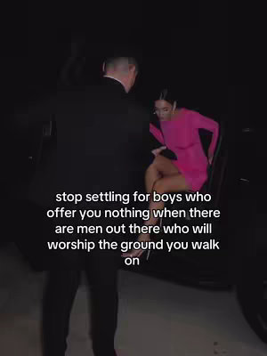 A woman in a bright pink dress steps out of a dark car, assisted by a man in a black suit. Text overlayed on the image reads, "stop settling for boys who offer you nothing when there are men out there who will worship the ground you walk on". The background is dimly lit, emphasizing the subjects.