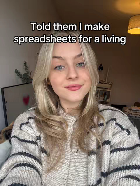 A woman with blonde hair and a striped sweater is centered in a selfie-style shot, with text overlayed at the top, and a blurred background showing an interior setting.