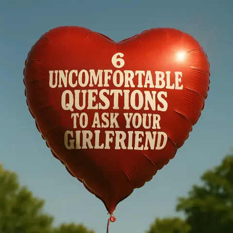 A red heart-shaped balloon is floating against a bright blue sky. White text is printed on the balloon, and the balloon is partially obscuring some green foliage.