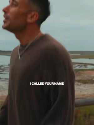 The cover image shows a man facing slightly upwards on an overcast day, with fields and a body of water in the background. Text overlayed on the image reads, "I CALLED YOUR NAME".