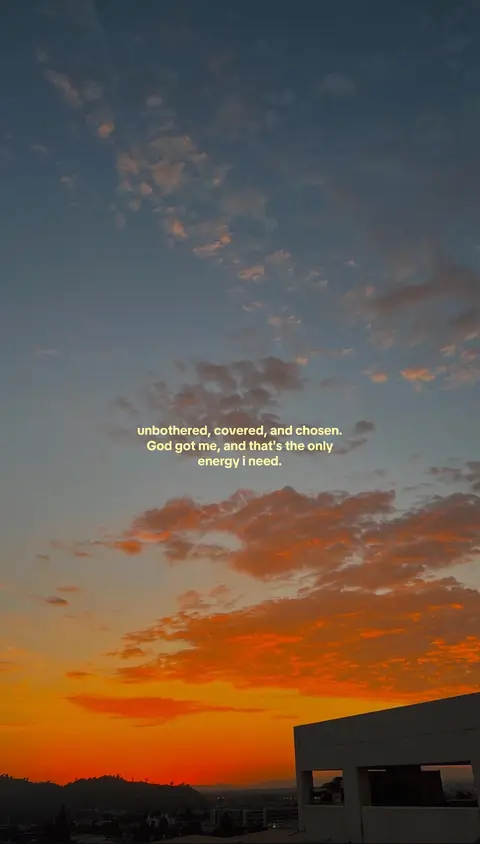 A vertical shot of the sky at sunset. Orange and red hues color the lower part of the image, suggesting the sun is setting behind a dark silhouetted landscape. The upper part of the image is a gradient of blue and scattered clouds. Text is overlaid on the sky.