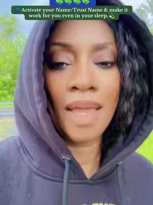 A woman wearing a dark blue hoodie and hood speaks directly to the camera. Above her head, a text box displays text related to activating a name or trust name.